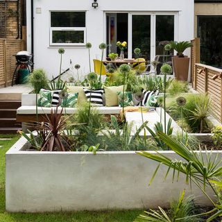 house exterior with garden and seating area