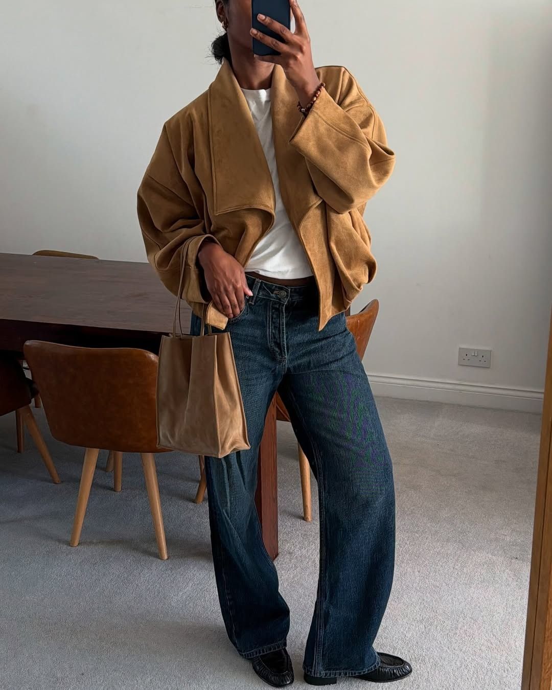 @nlmarilyn in dark-rinse jeans, suede jacket, white tee, and loafers