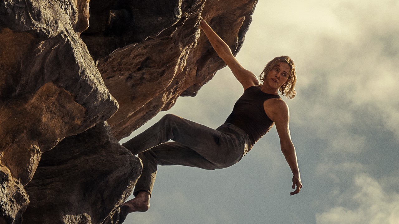 Sasha climing the mountain in Apex