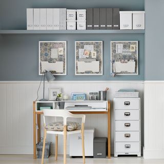 Two tone home office with desk, filing cabinet and overhead storage
