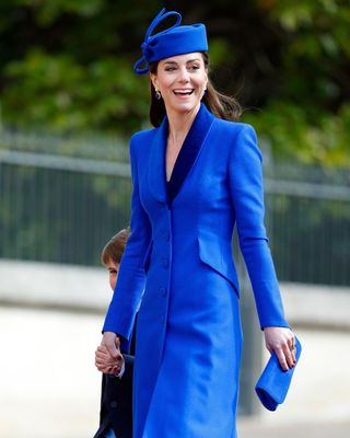 Kate Middleton wearing a cobalt blue coat dress and hat