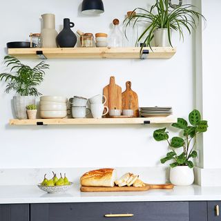 black kitchen with wooden shelves