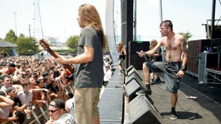 Mark Morton and Randy Blythe work the pit during a daytime set at a 2004 festival