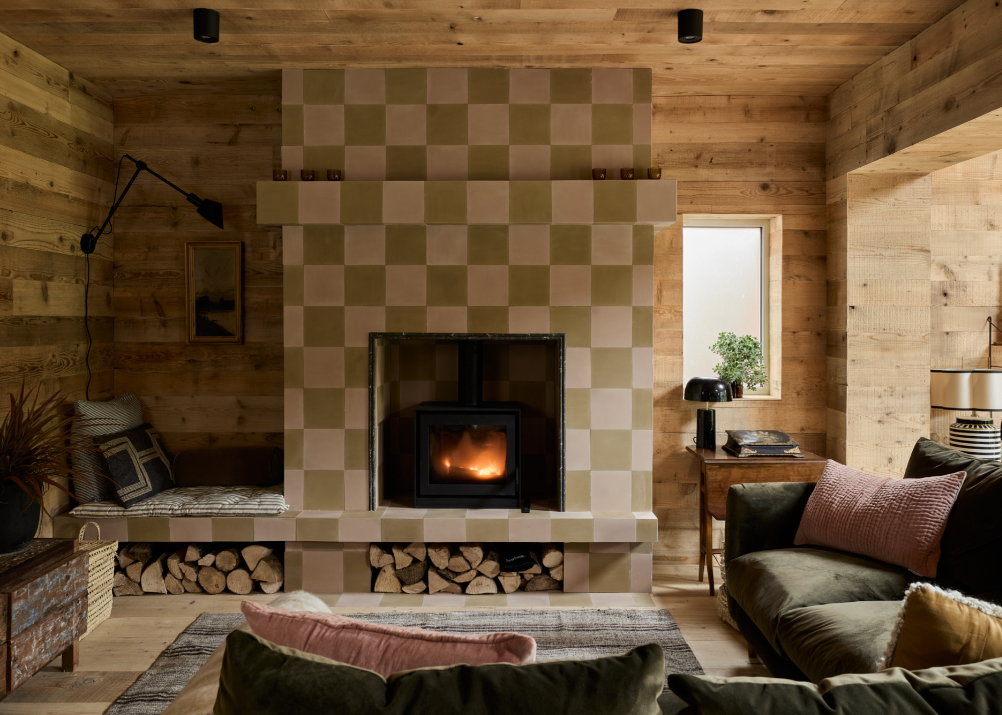 wooden clad living room with a checkerboard fireplace and a big L shaped sofa