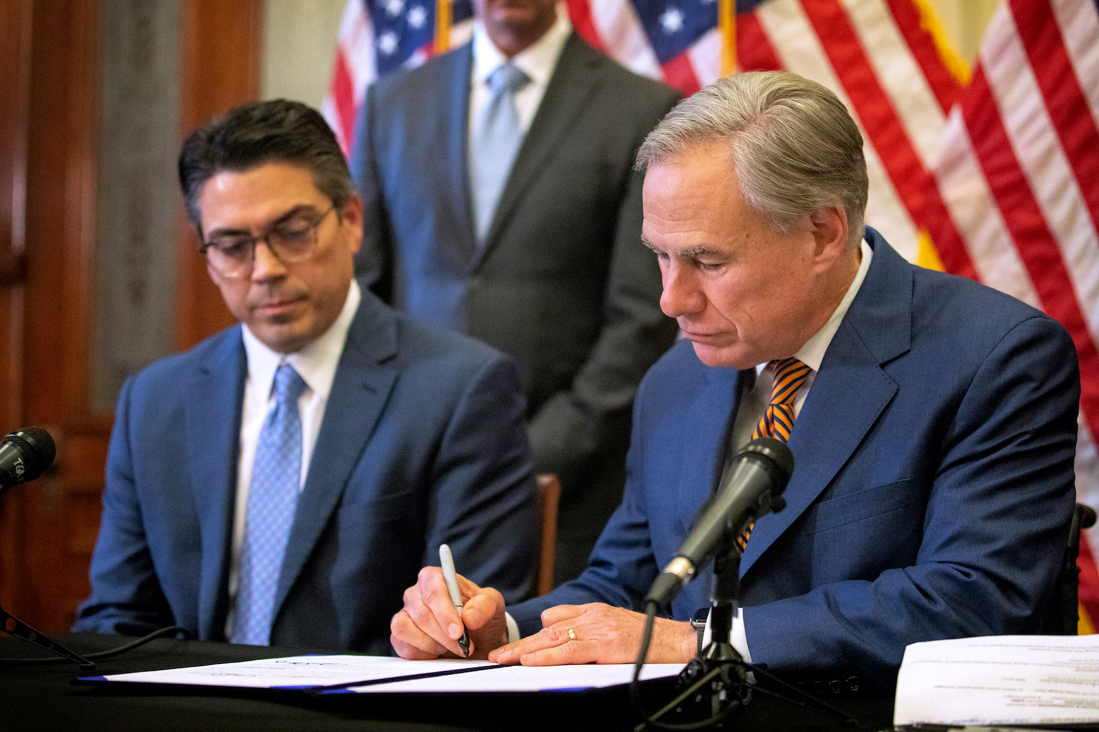 State Rep. Chris Paddie watches as Texas Governor Greg Abbott signs Senate Bills 2 and 3 during a press conference at the Capitol on June 8, 2021 in Austin, Texas. Governor Abbott signed the bills into law to reform the Electric Reliability Council of Texas and weatherize and improve the reliability of the state's power grid.