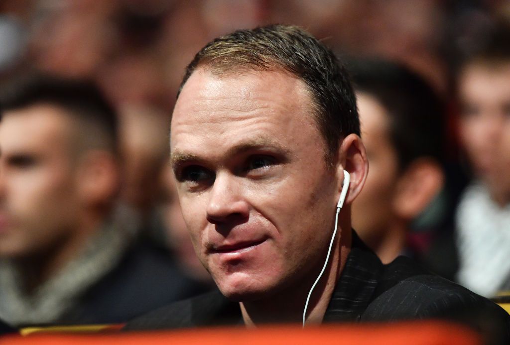 Chris Froome listens to the presentation via an audio translation