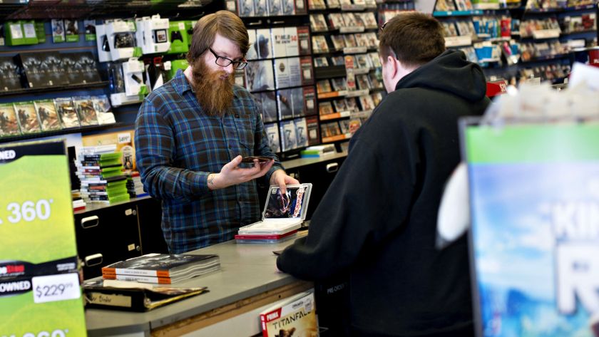 Employee Matt Doyle looks over games being traded in by a customer at a GameStop Corp. store in Peru, Illinois, U.S., on Wednesday, March 26, 2014. GameStop Corp. is depending on new generation machines from Sony Corp. and Microsoft Corp. to breathe life into an industry hurt by consumers shifting play to social networks and mobile phones. Photographer: Daniel Acker/Bloomberg via Getty Images 