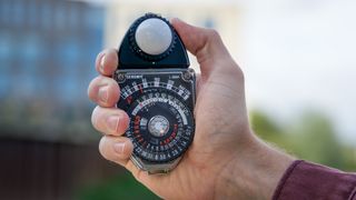 Man holding Sekonic Studio Deluxe III L-398A light meter