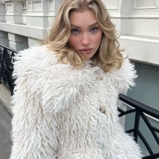 Elsa Hosk wearing a faux-fur cream jacket and cream corduroy pants from Helsa.