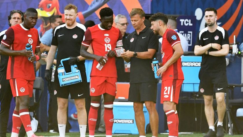 Jesse Marsch Head Coach of Canada talking with Alphonso Davies #19 and Jonathan Osorio #21 of Canada while an injury is attended to on the field during the CONMEBOL Copa America group A match between Peru and Canada at Children&#039;s Mercy Park on June 25, 2024 in Kansas City, Kansas.