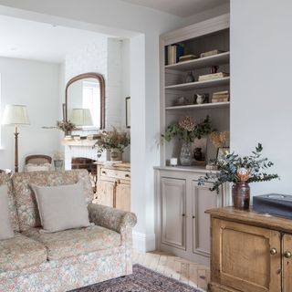 living room with white wall and cushion on sofa