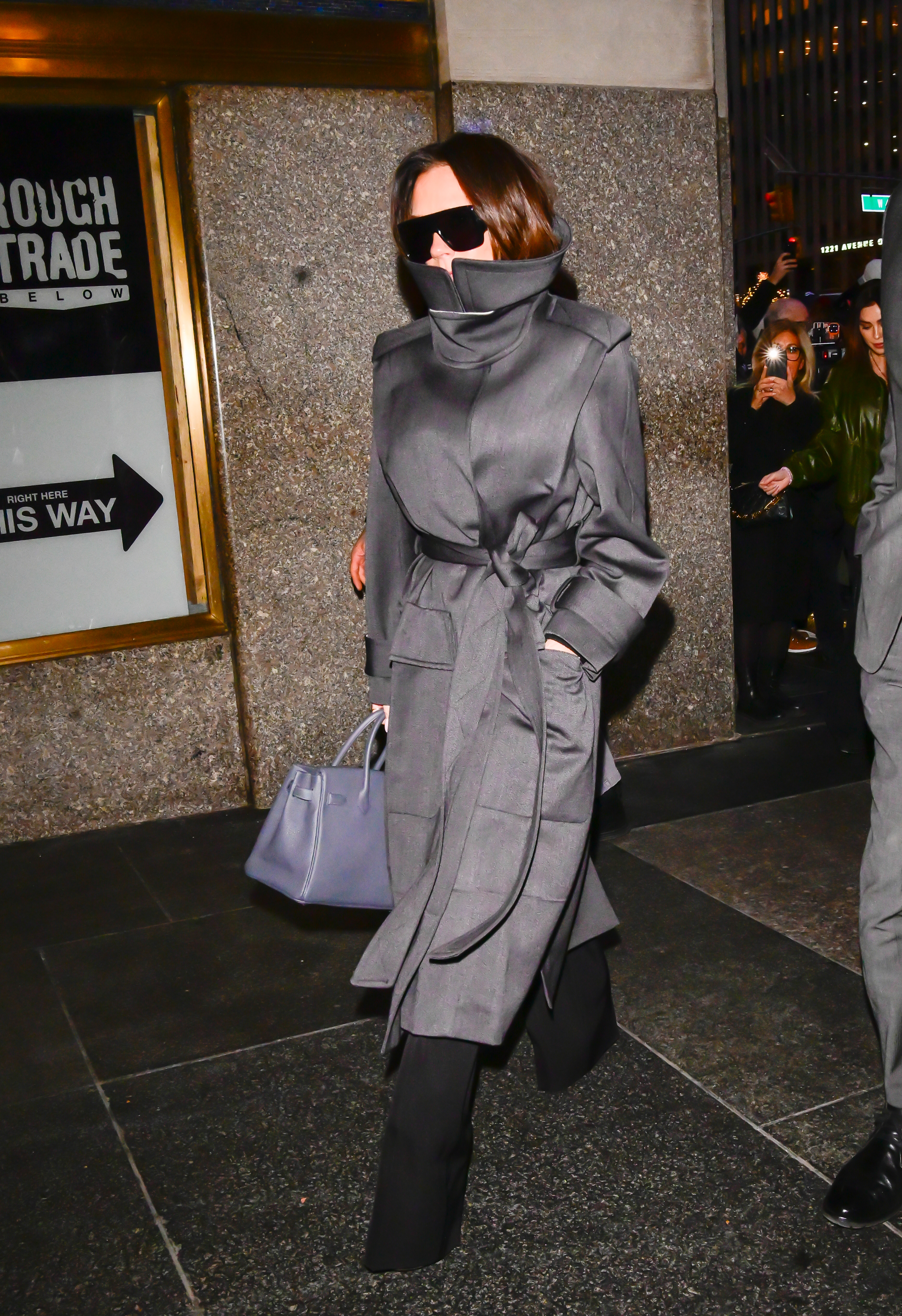 Victoria Beckham wears a high neck coat