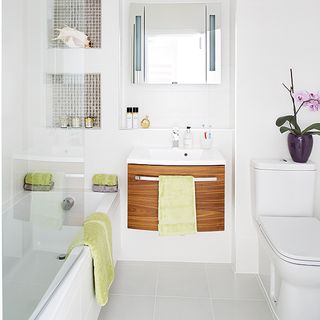 bathroom with white wall and bathtub and washbasin and toilet