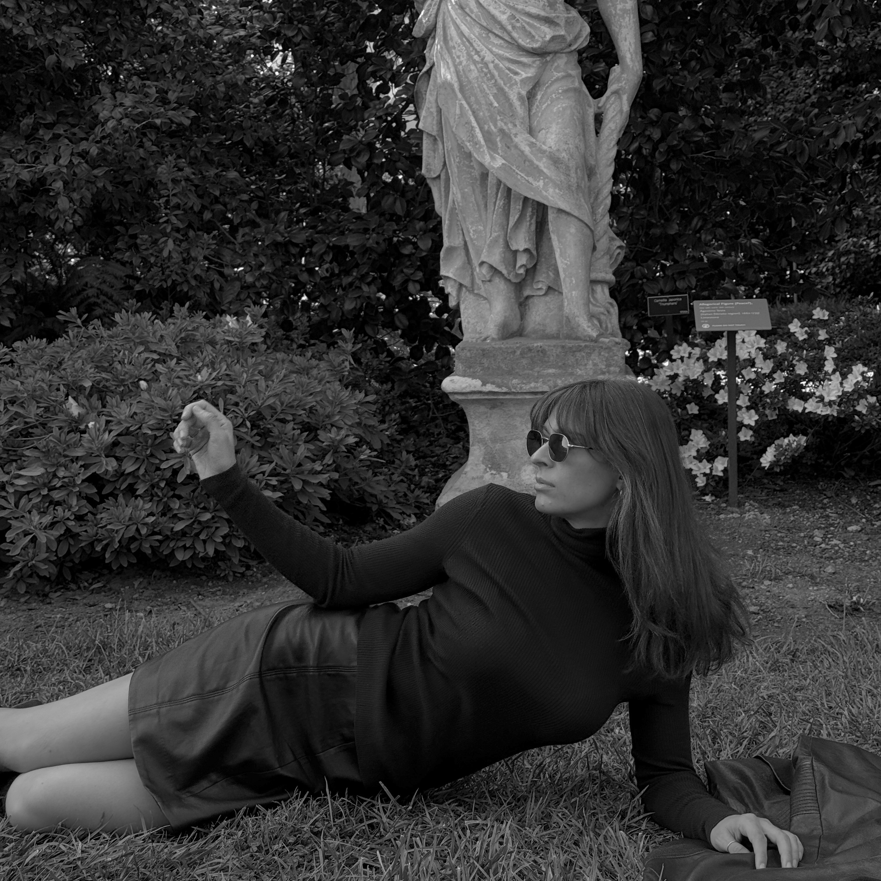 Kathryn Zahorak wearing brown turtleneck, leather skirt, and knee high boots