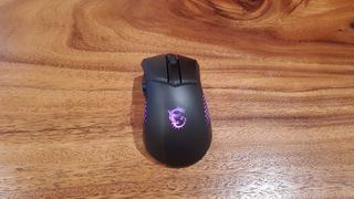 black MSI Clutch GM51 gaming mouse on a wooden table