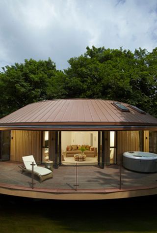 Room at the Treehouse Suites, Chewton Glen Hotel & Spa, Hampshire, UK with balcony with hot tub and sun loungers