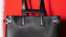 Dunhill leather tote bag on red background close up