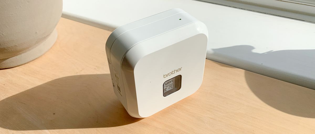 Brother P-Touch Cube Plus PT-P710BT thermal printer on a wooden table