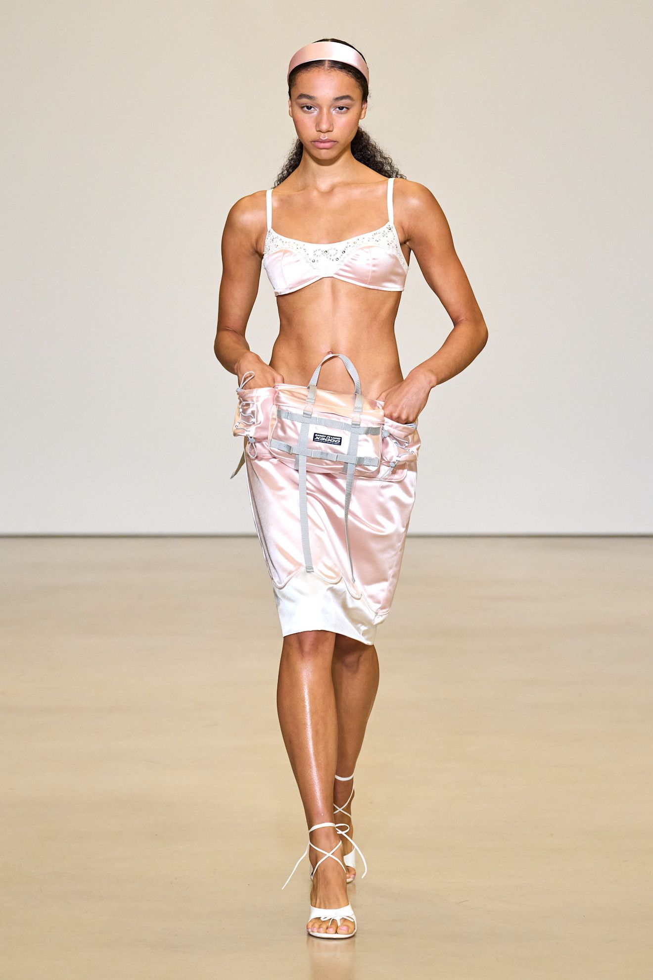 Spring/summer 2027 model wearing a bra top on the runway during fashion month.