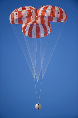 NASA's Orion human space capsule rides toward Earth with its three main parachutes deployed, during a test on March 8, 2017.