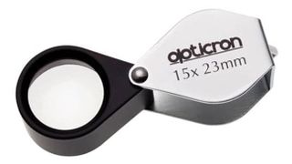 Product shot of the Opticron 15x 23mm Folding Metal Loupe