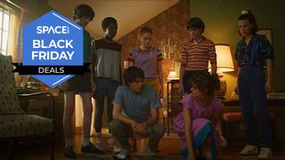 Five kids are stood in a living room looking down at two older kids who are kneeling down, the space.com logo is in the top left corner