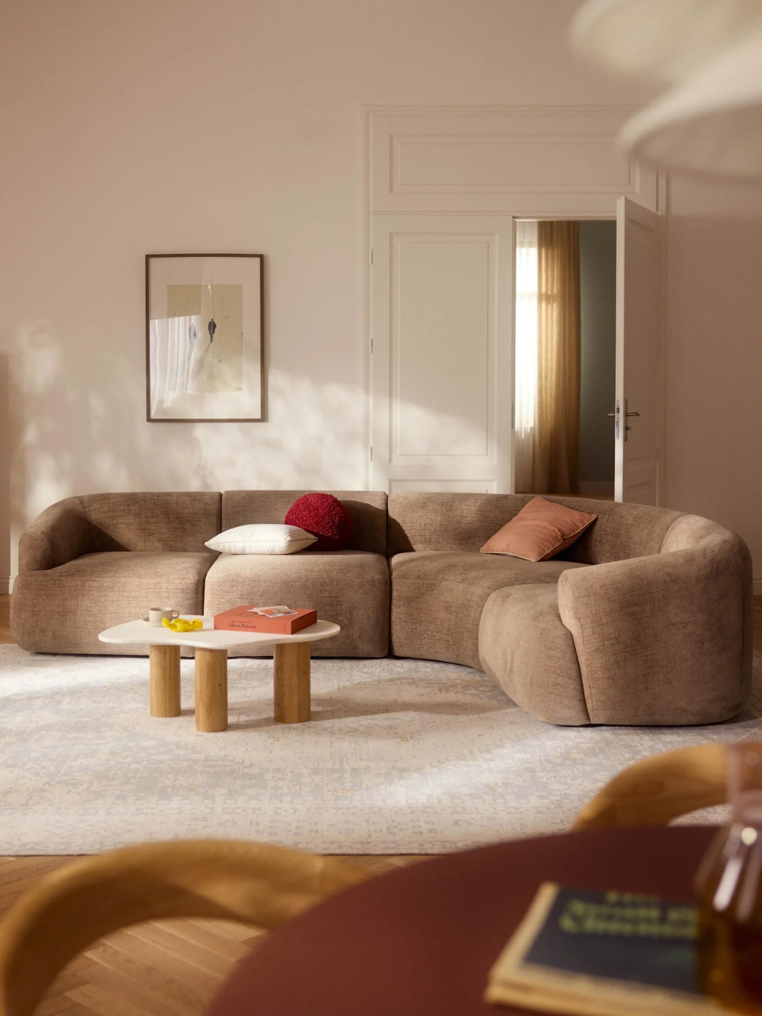 A curved brown modular corner sofa from Westwing