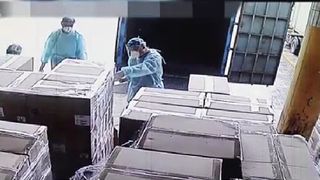 A still of a video showing a Chinese customs officer checking graphics cards on entry