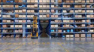 Image of warehouse with multiple shelves of containers and pick truck