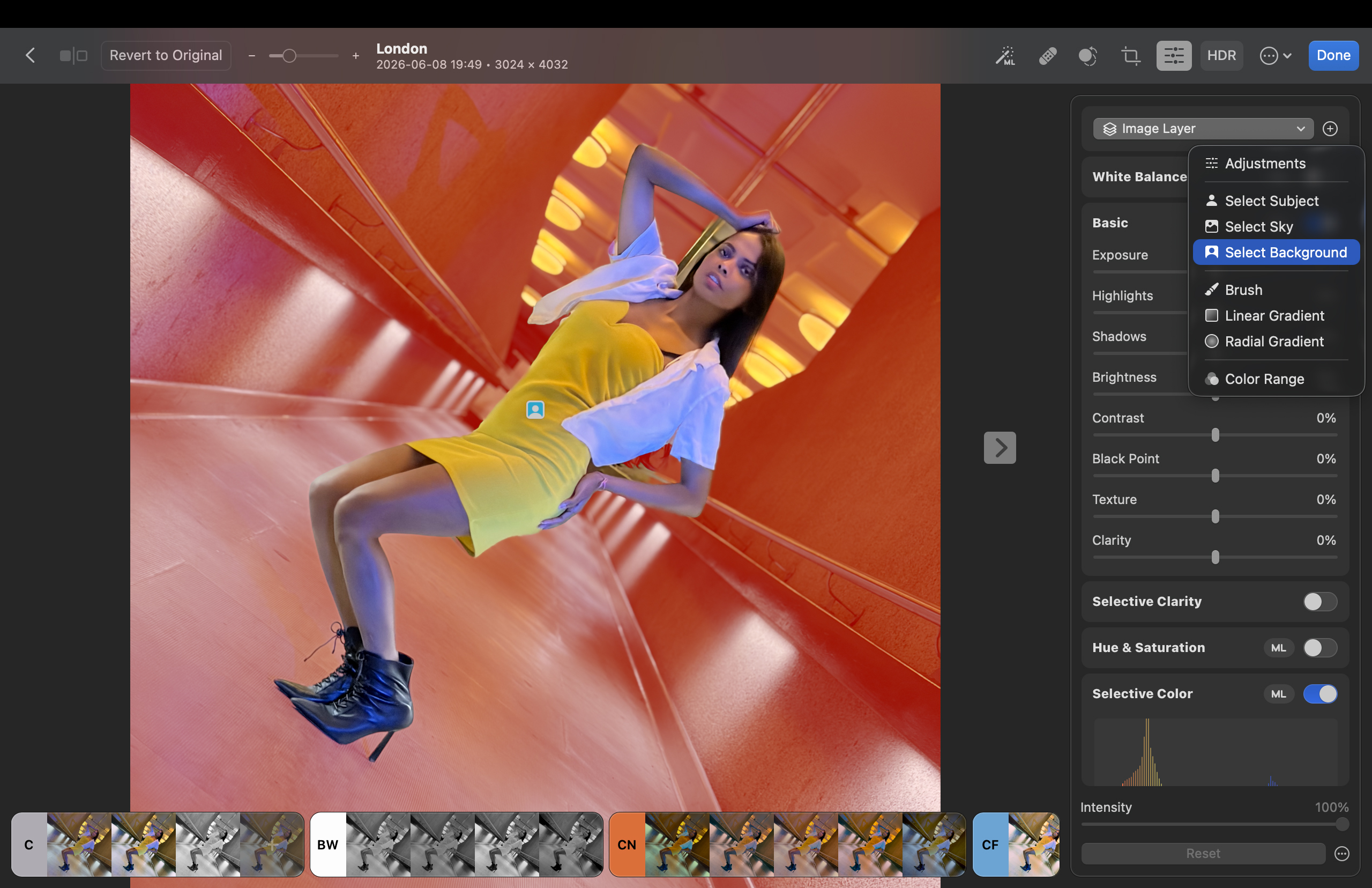 Shot of the mask selection tools in the Layer panel. A model poses in a corridor. A mask has been used to select the shot&amp;rsquo;s background. The masked background area is indicated by a red overlay.