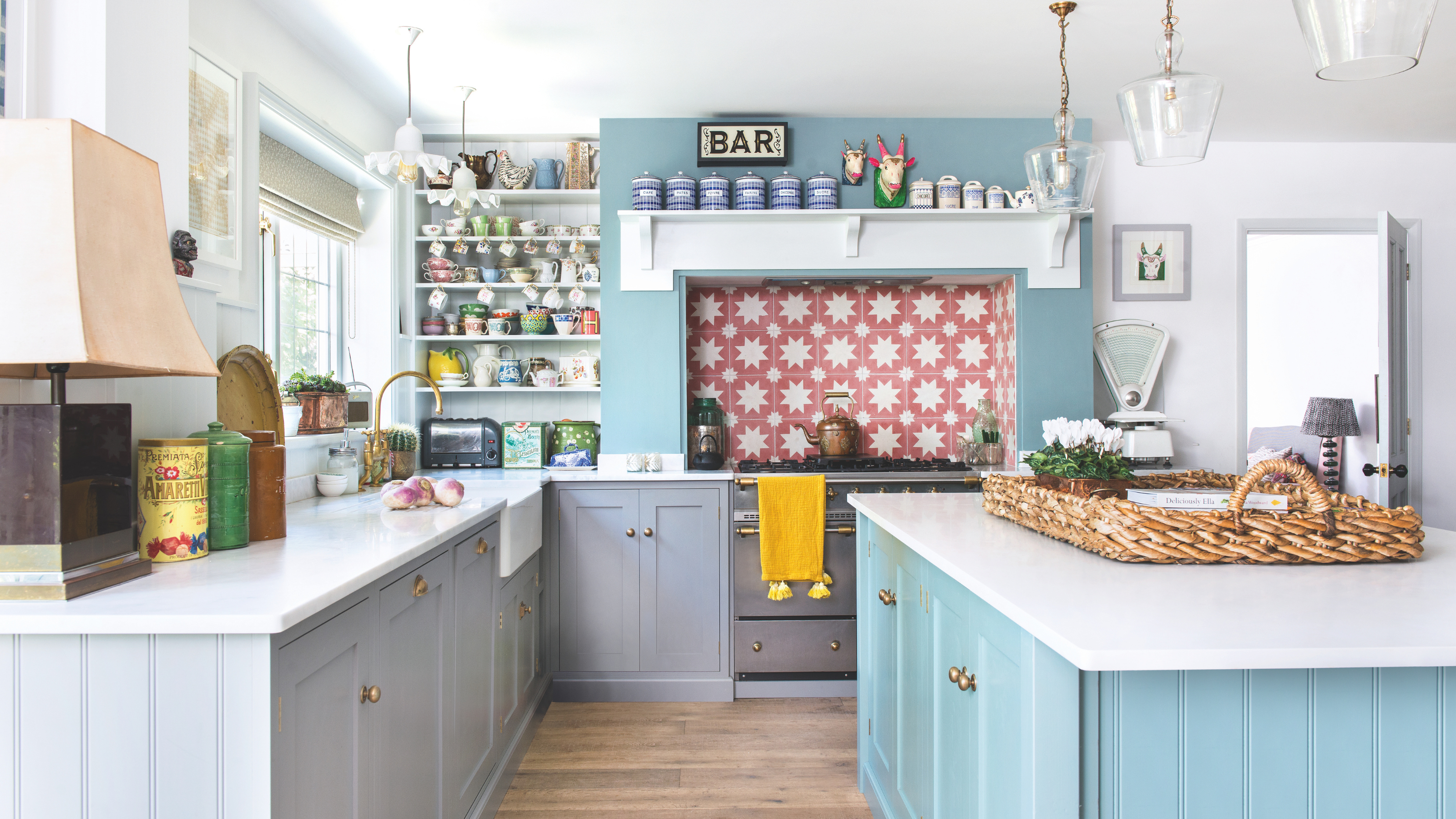 Bright and airy sky blue kitchen, with a red star tiled backsplash.