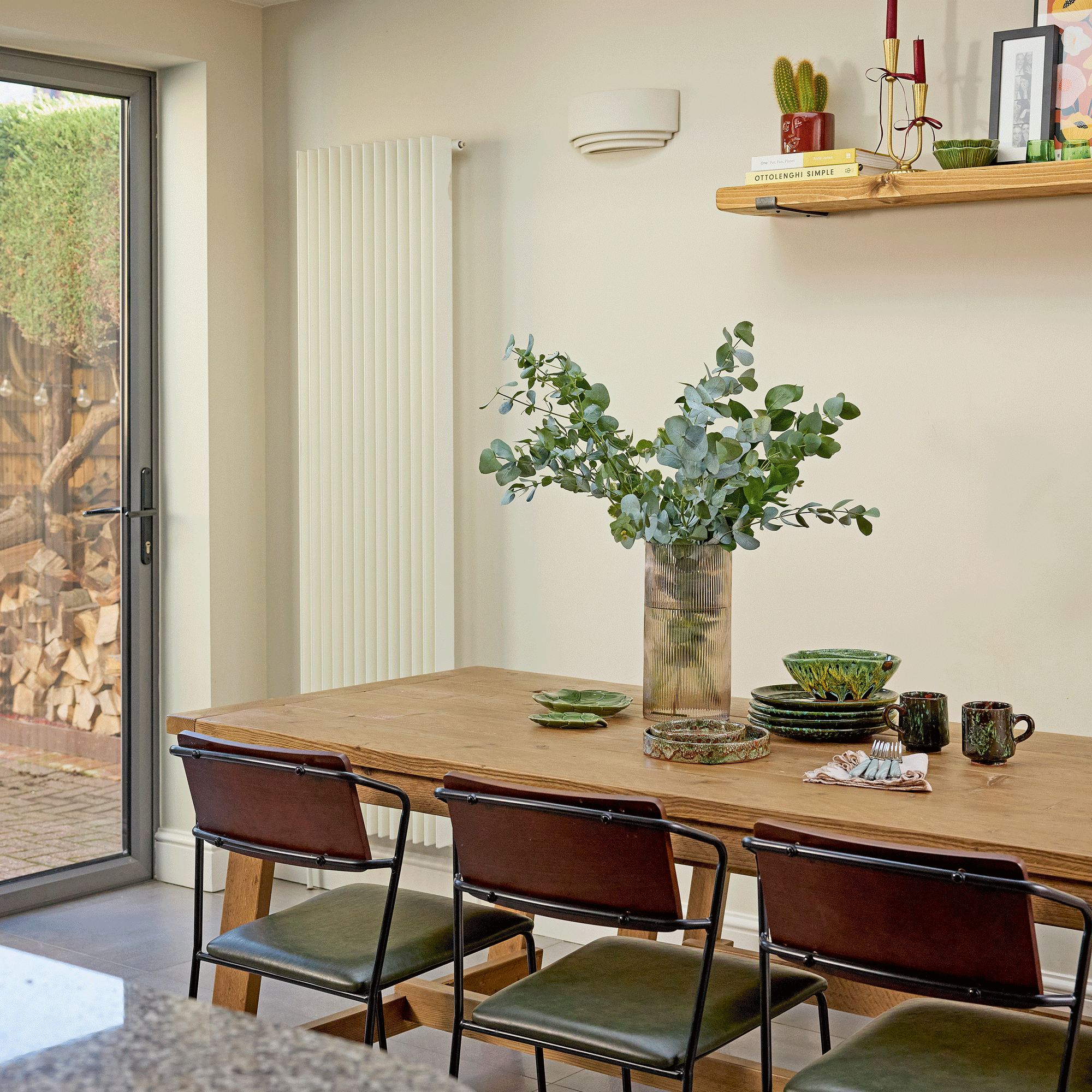 Open-plan kitchen diner with vintage dining chairs and neutral walls