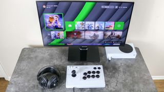 The 8BitDo Arcade Stick for Xbox with an Xbox Series S on a desk