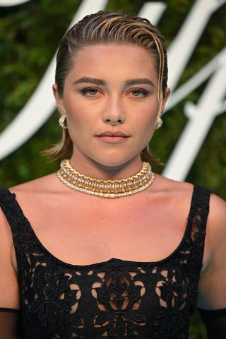 Florence Pugh is pictured with her short hair slicked back at the Tiffany & Co. "Vision & Virtuosity" Brand Exhibition Opening Gala at Saatchi Gallery on June 09, 2022 in London, England.