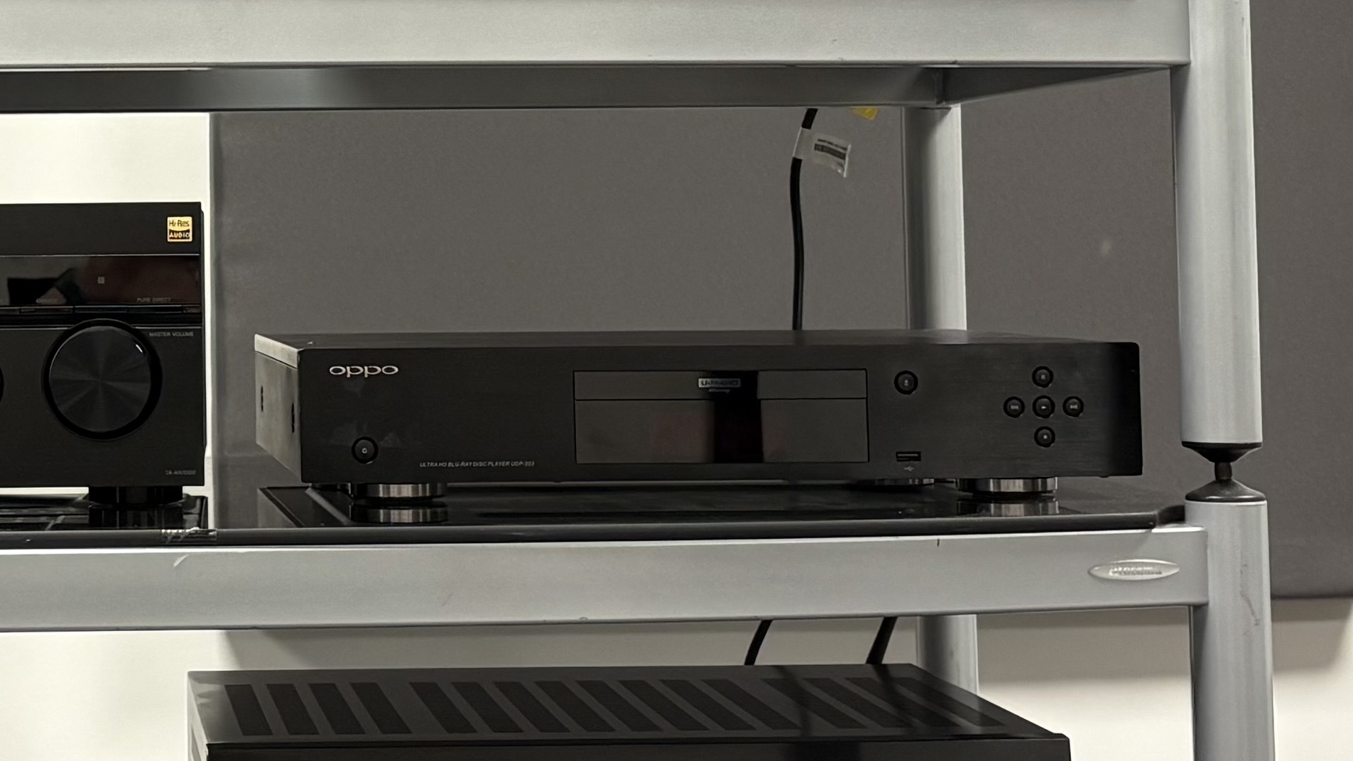 Oppo UDP-203 Blu-ray player on a metal shelf