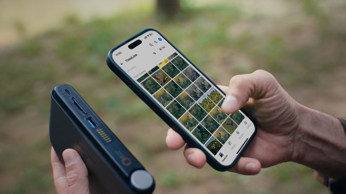 A lifestyle image of the PocketCloud connected wirelessly to a phone