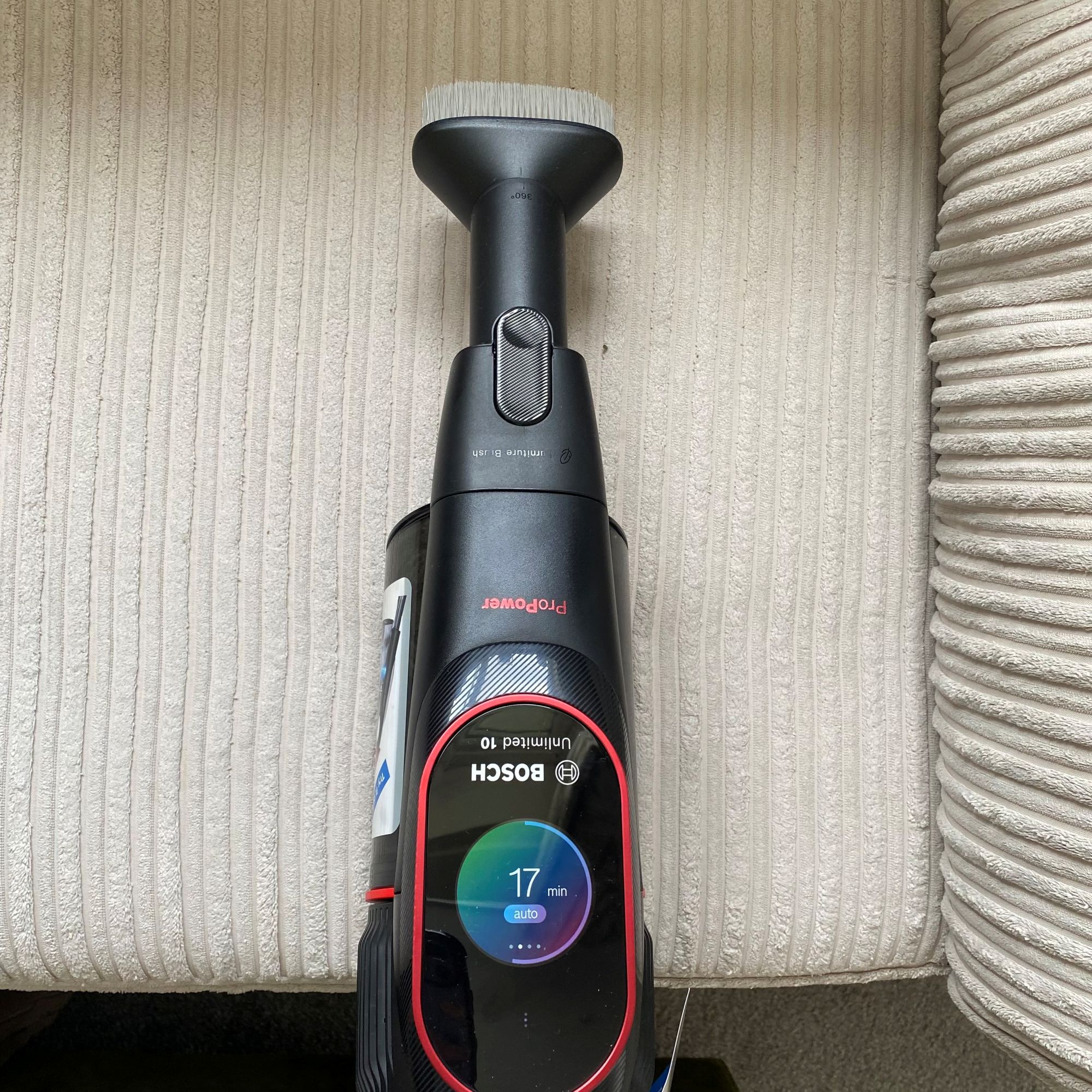 Bosch Unlimited 10 ProPower cordless vacuum in handheld mode cleaning sofa
