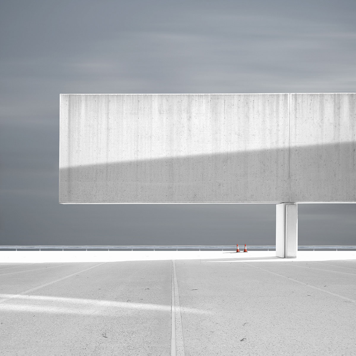 A minimalist white brutalist structure in the wilderness