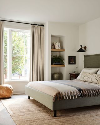 a simple white bedroom with built in shelves