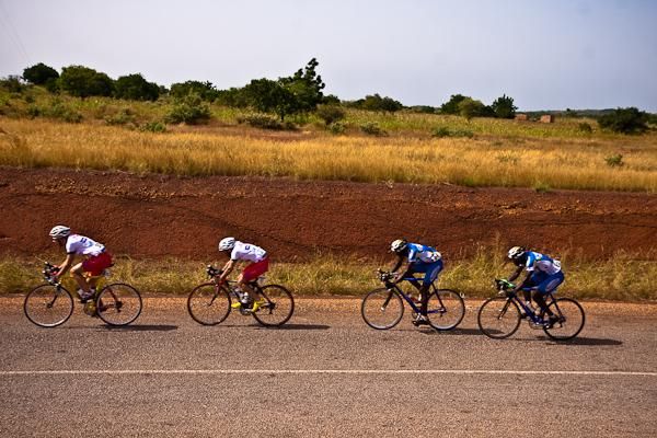 The peloton rides single-file in hot pursuit.