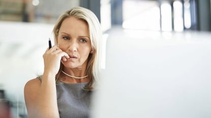 A woman looks at a computer skeptically.