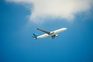 Passenger jet airplane over clouds