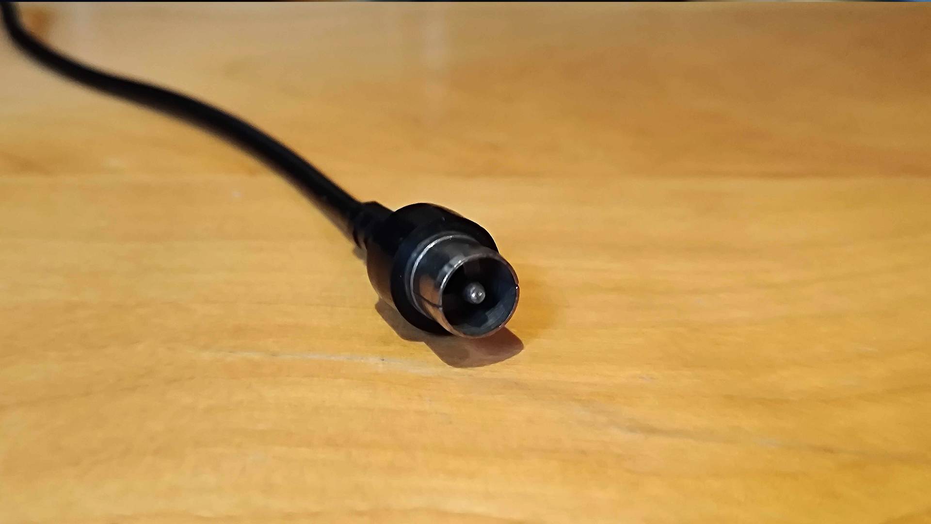 RF cable on woodgrain surface.