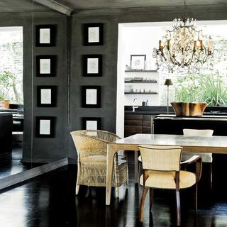 dinning room with chandelier and black flooring