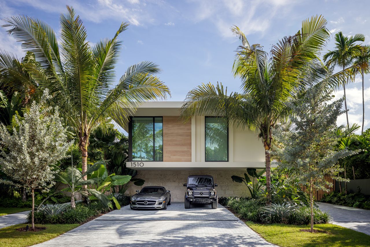 Sunset Islands Residence by Strang Design entrance exterior among foliage