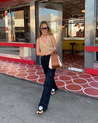 woman wearing halter top and baggy jeans