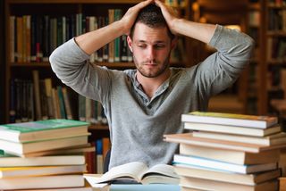 A young man looks stressed about his studies