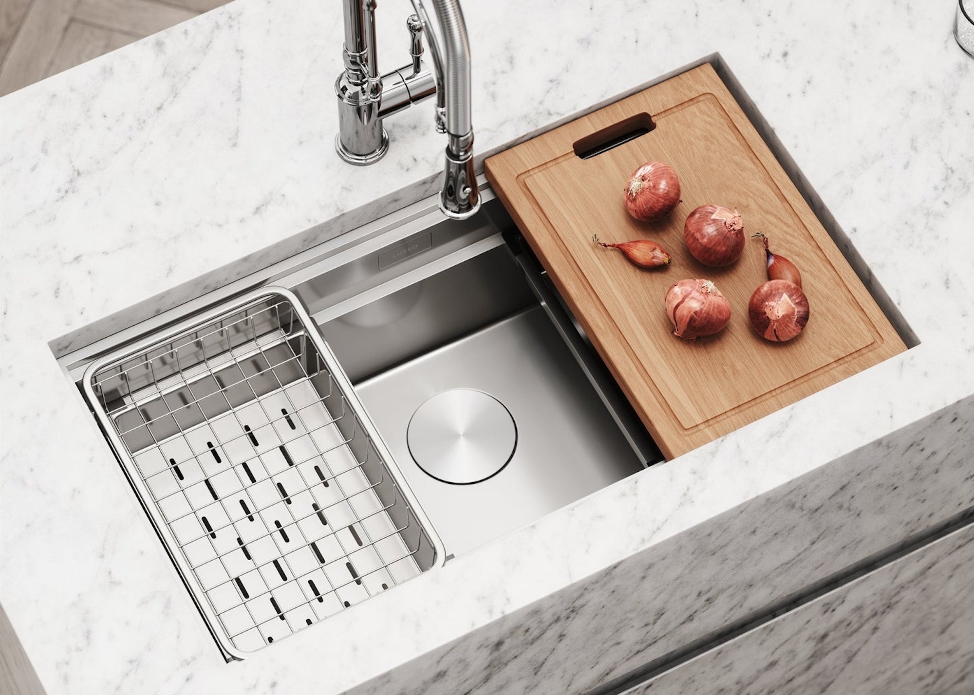 A kitchen with a steel workstation sink. On one side is a chopping board with onions on top.