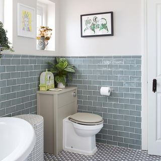 bathroom with frame on wall and flower on vase