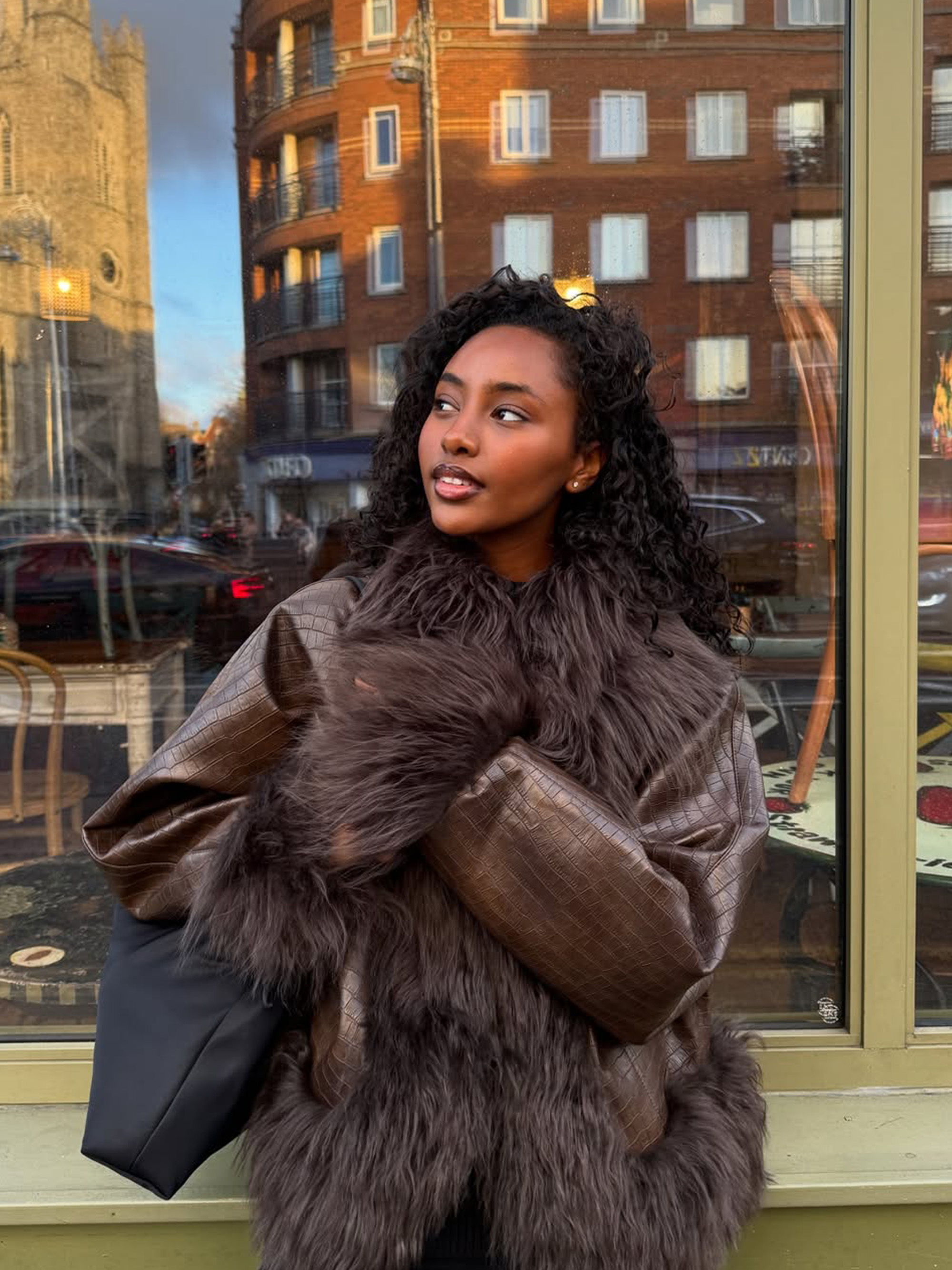 Rayan Xasan with juicy curls and warm, bronzed makeup